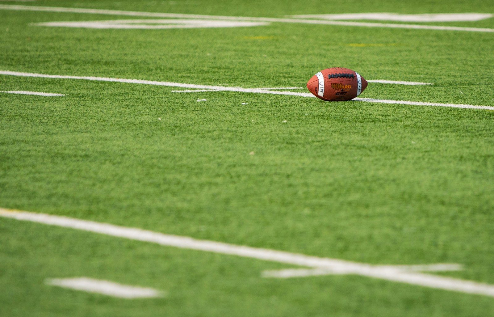 A football laying on a football field