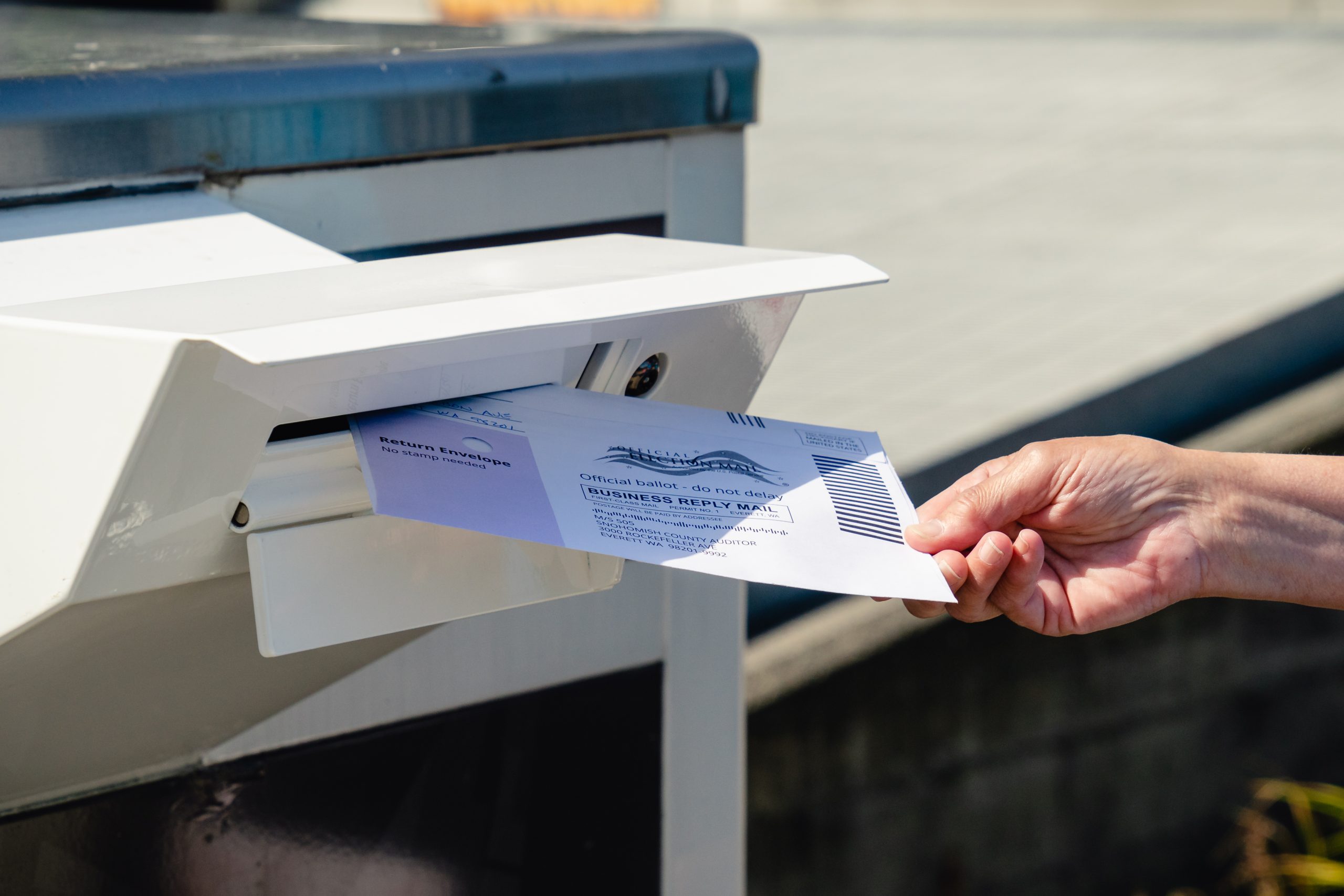 Everett, WA USA / 07/30/2020: Dropping Mail in Ballot into mail box
