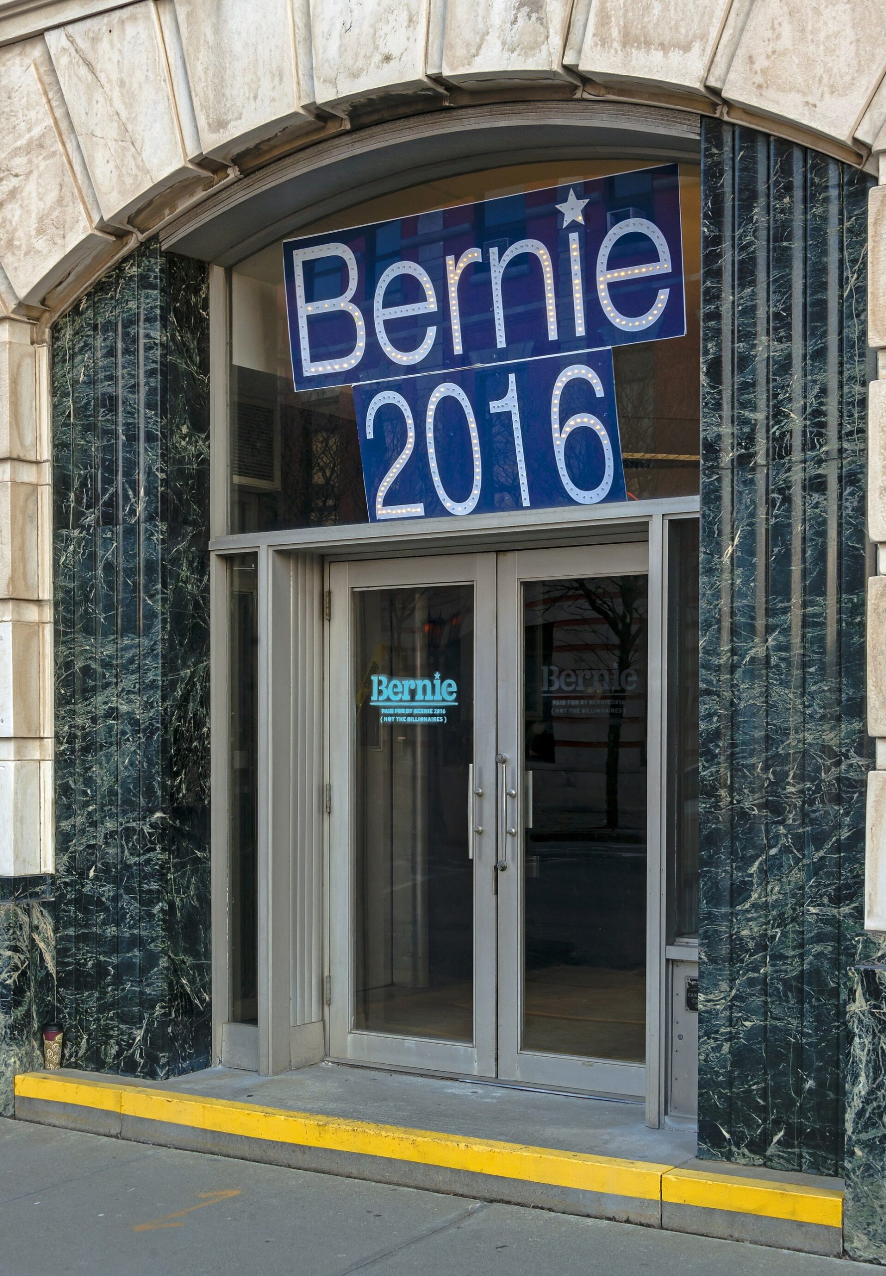 Poughkeepsie Savings Bank entrance with Bernie Sanders sign
